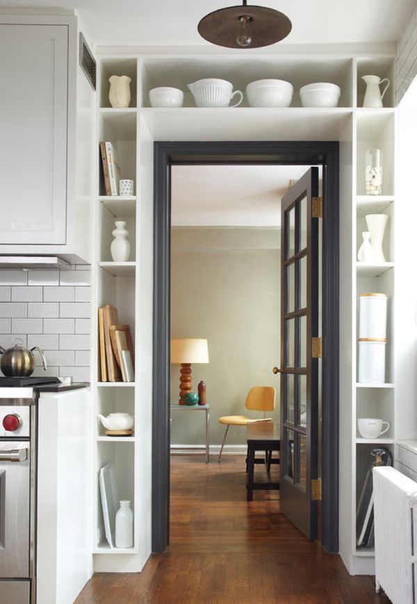 For things like glasses or cups, you can create special storage compartments around the door frame. 
