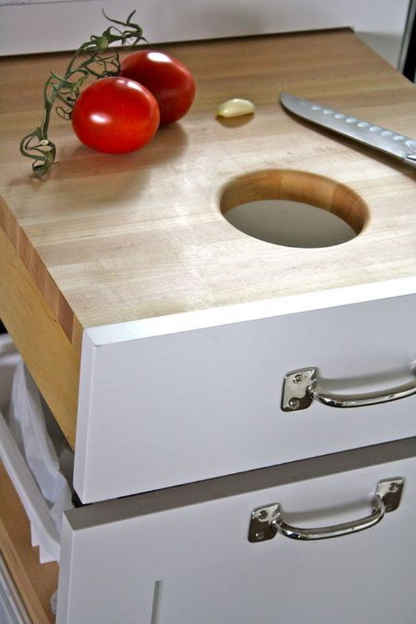 Place the cutting board in a drawer directly above the trash can so that you can scrape in the unwanted residue directly. 