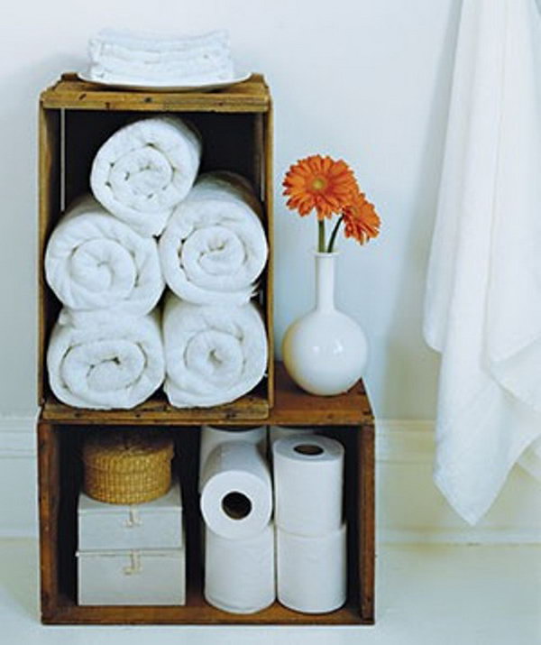Old wooden wine boxes have a natural vintage charm and are ideal as holders for additional toilet paper and rolled bath towels. 