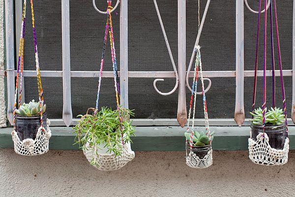 The hanging planters consist of a variety of colored embroidery threads and recycled spice jars. It is perfect for your balcony, patio or window decoration. 