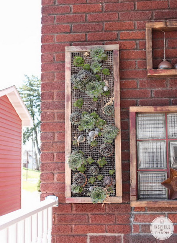 Vertical garden with wooden frame. It allows plants to extend upwards instead of growing along the surface of the garden. Doesn't take up much space and looks so beautiful at the same time.