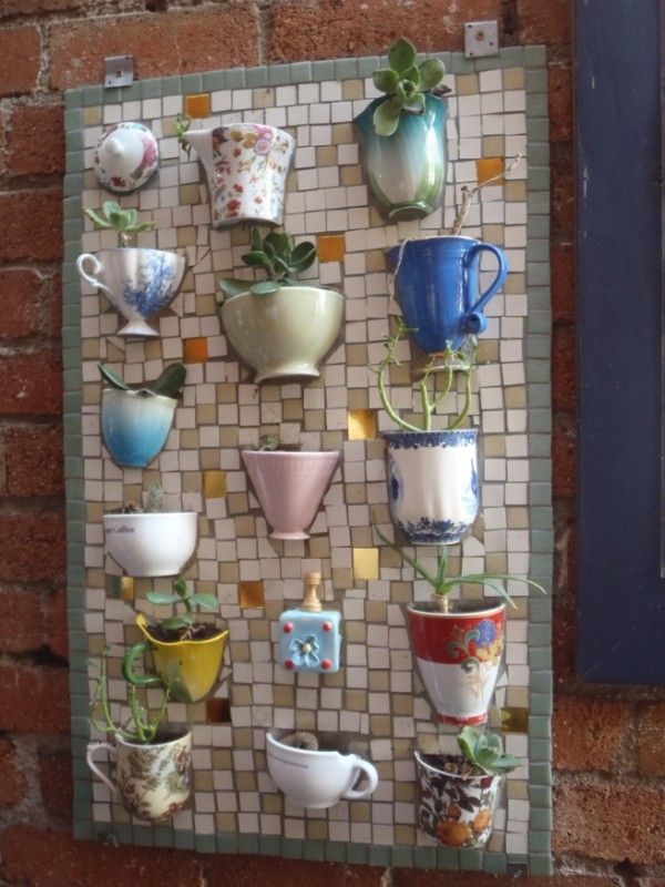 Teacups mosaic plate. It allows plants to extend upwards instead of growing along the surface of the garden. Doesn't take up much space and looks so beautiful at the same time.