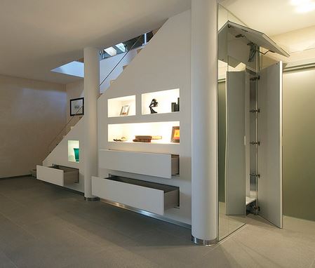 under the stairs closet. The space under a staircase can be used to clear everyday clutter.