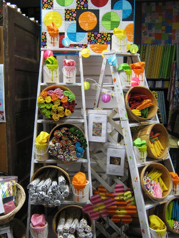 It is a decorative use of vintage ladders for handicraft exhibitions or retail stores.