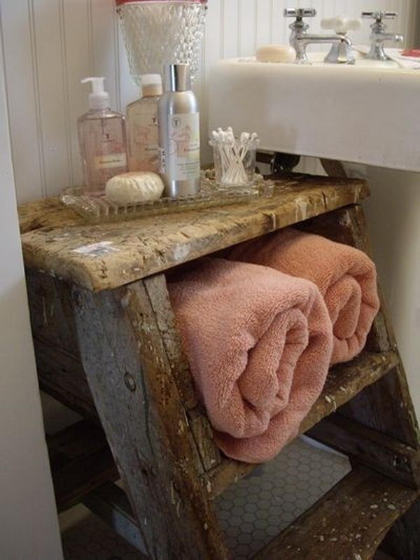 Use the old wooden ladder as a table and shelf in the bathroom.