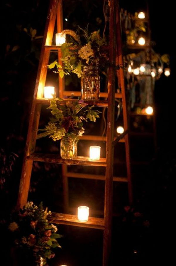 It's a nice garden party idea with glasses and candles on a ladder.