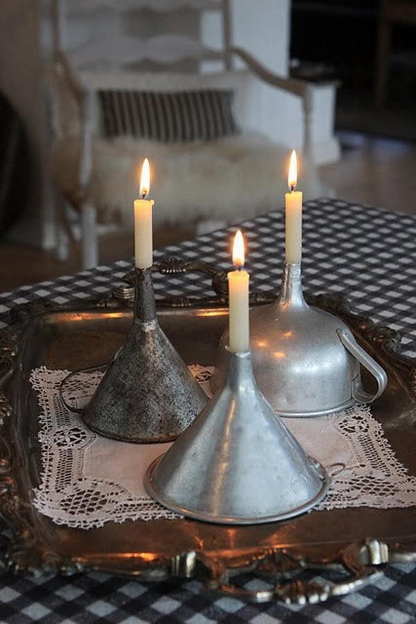 Make candle holders with vintage kitchen funnels,