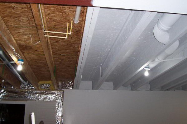 Industrial look basement ceiling painting. Instead of drywall or suspended ceilings, paint everything with an airless sprayer in white to make it uniform, but harmonious and bright.