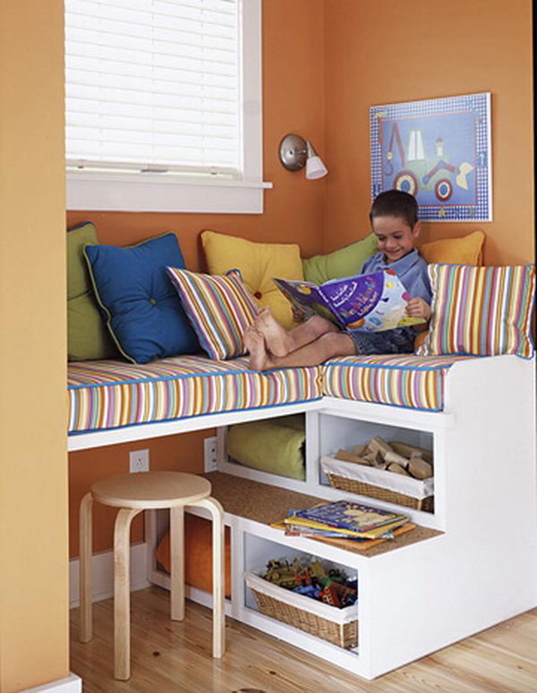 Stairs as storage. This unique storage unit also serves as a fun seat for children who can climb up on the cozy pillows. The open shelves are perfect for storing blankets that are easily available on cooler days.