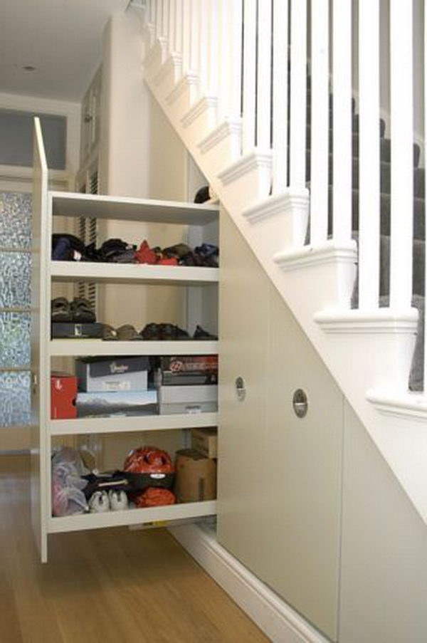 Pull-out storage space under the stairs. High broom cupboard with pull-out staircase.