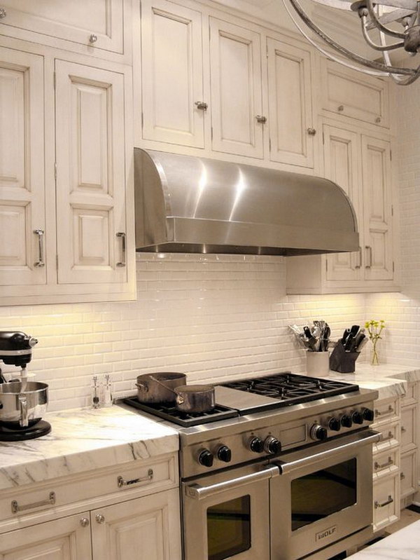 Retro cream-white kitchen set with marble top plus white ceramic subway tiles backsplash. 