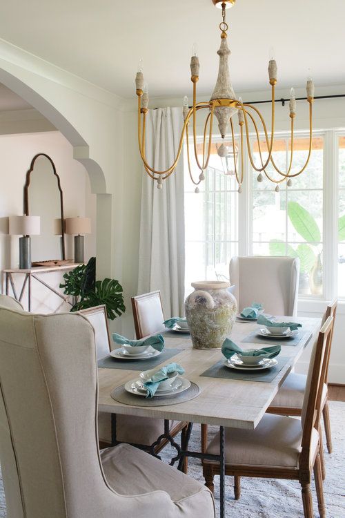 Dining Room with Gabby Clay Chandelier and Archway Detail by .