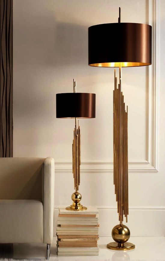 Luxury golden floor and table lamp set for a glamorous living room .