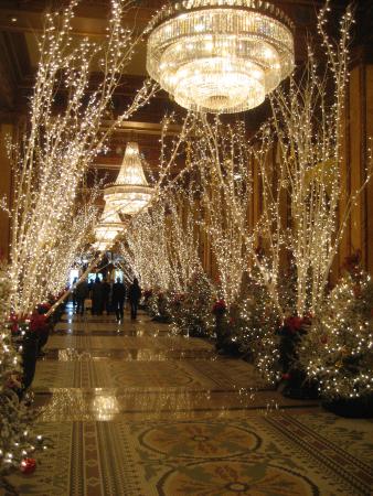 Grand lobby with huge chandeliers, decorated for Christmas .