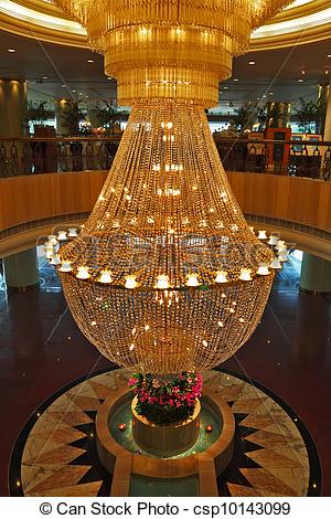 A huge magnificent crystal chandelier adorns the lobby expensive .