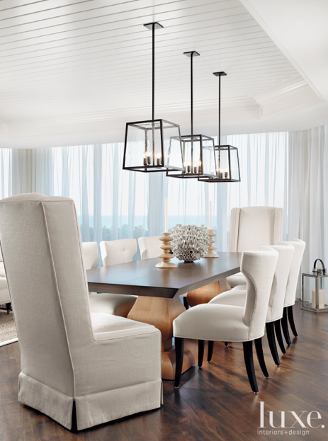 In this stunning dining room, three Holly Hunt light fixtures are .