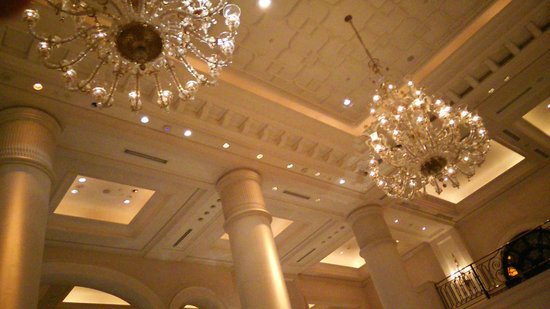 The ornate chandeliers above the lobby - Picture of The Leela .