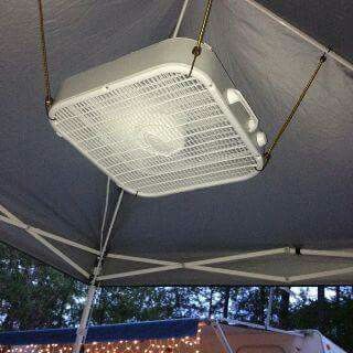 Box fan and bungee cords as a ceiling fan under the canopy .