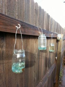 DIY upcycled glass jar lanterns made with empty jelly/salsa jars .