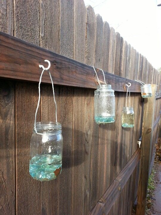 DIY upcycled glass jar lanterns made with empty jelly/salsa jars .