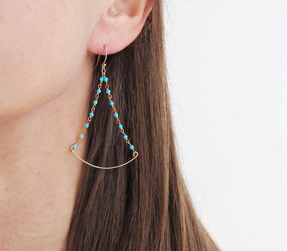 Small turquoise beads chandelier earrings with gold wire ear hook .