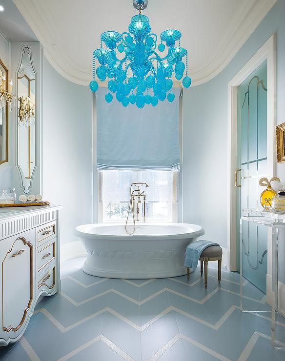 Turquoise blue bathroom features a curved nook filled with a .